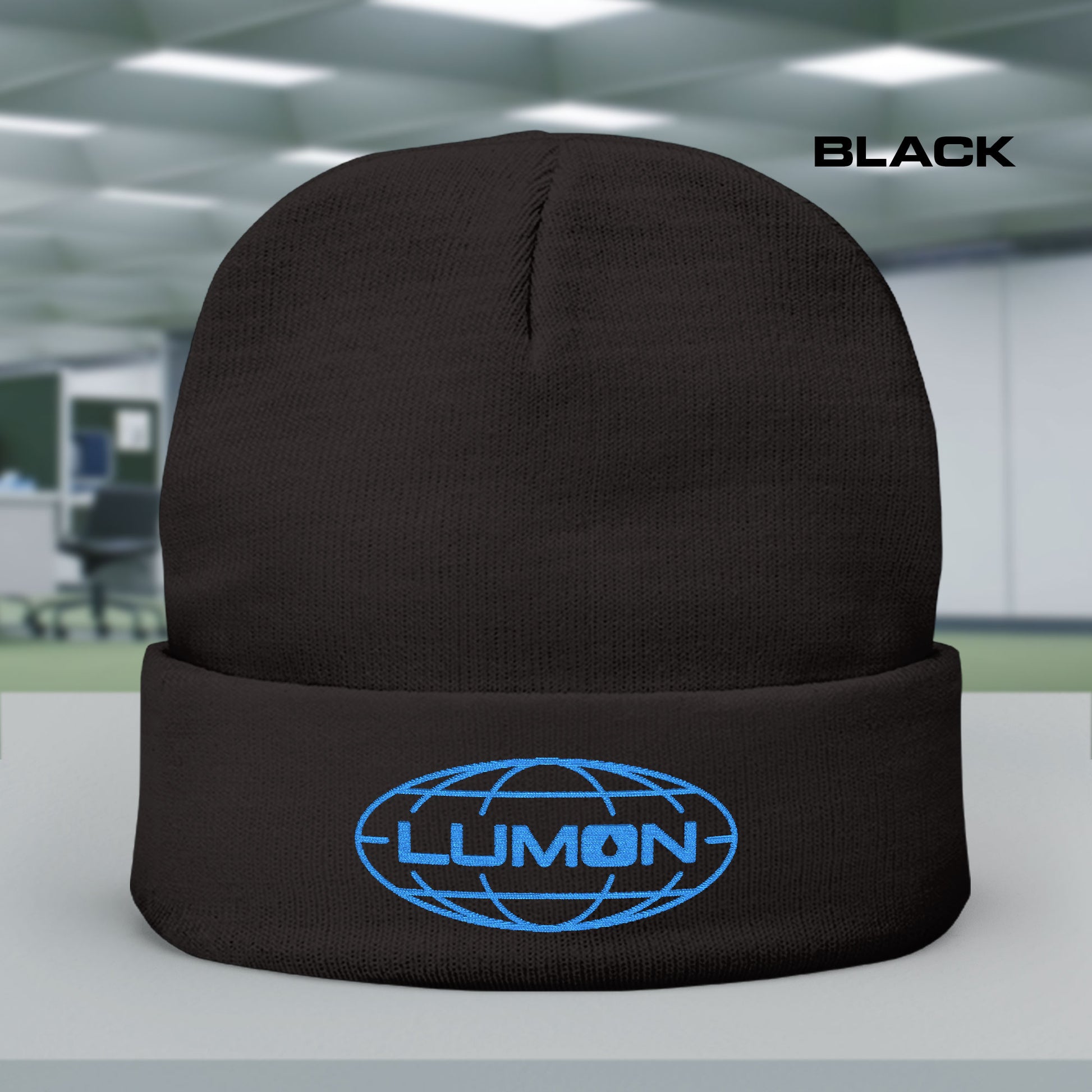 Black knit beanie with embroidered blue Lumon Industries logo from Apple TV’s Severance.