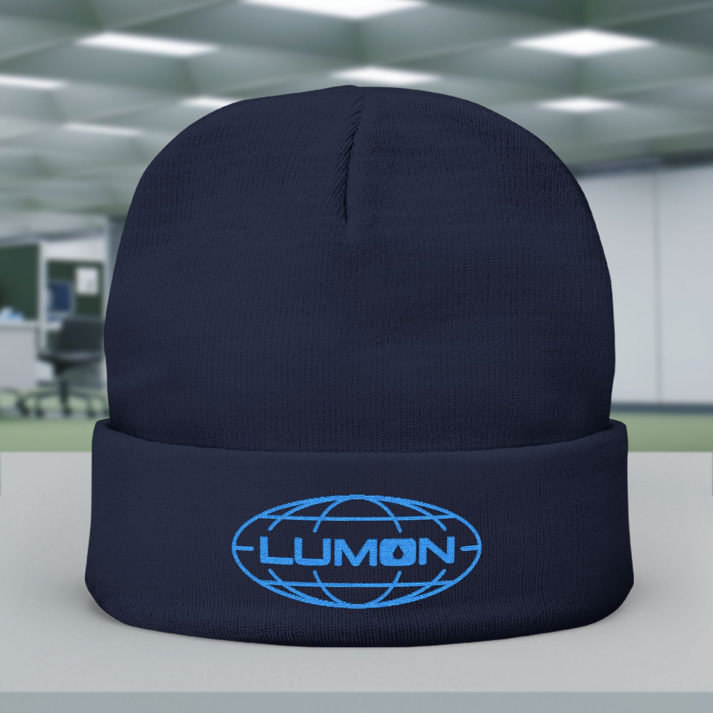 Front of Navy knit beanie with embroidered blue Lumon Industries logo from Apple TV’s Severance.