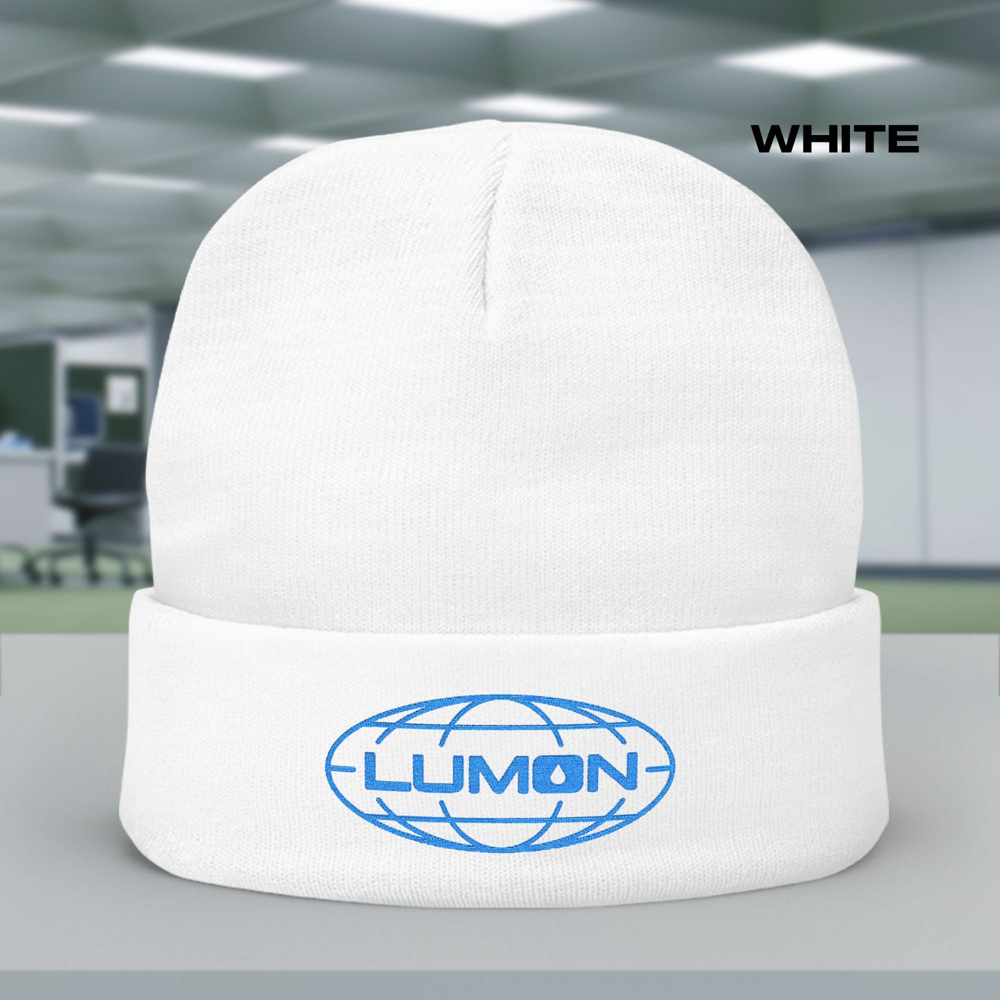 White knit beanie with embroidered blue Lumon Industries logo from Apple TV’s Severance.