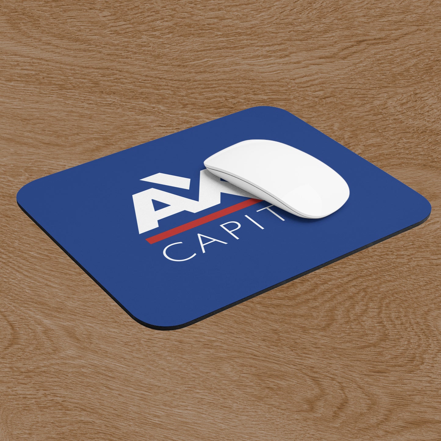 Angled view of blue Axe Capital mouse pad inspired by the TV show Billions, shown with a mouse on a wooden desk.
