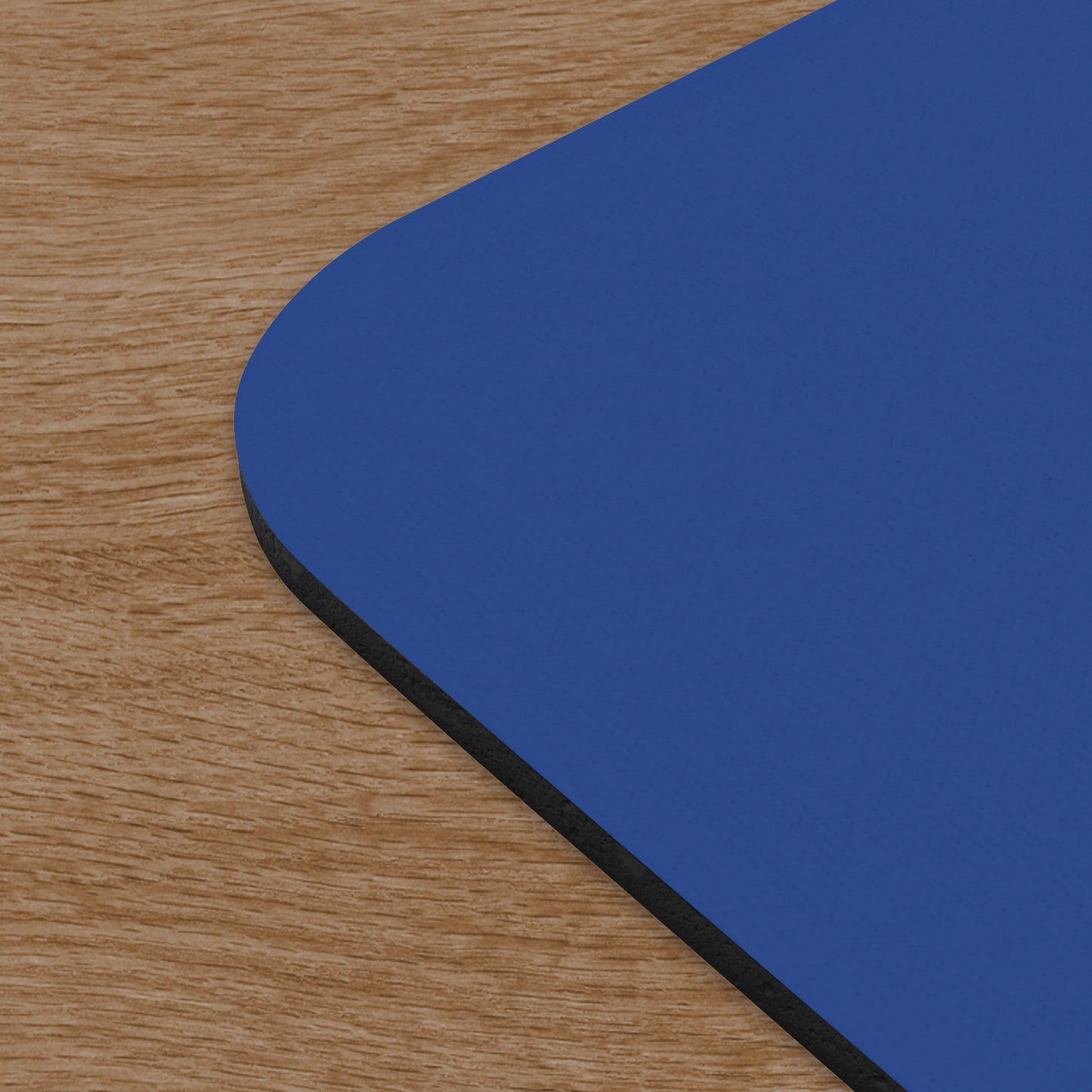 Closeup corner view of blue Axe Capital mouse pad inspired by the TV show Billions on a wooden desk.