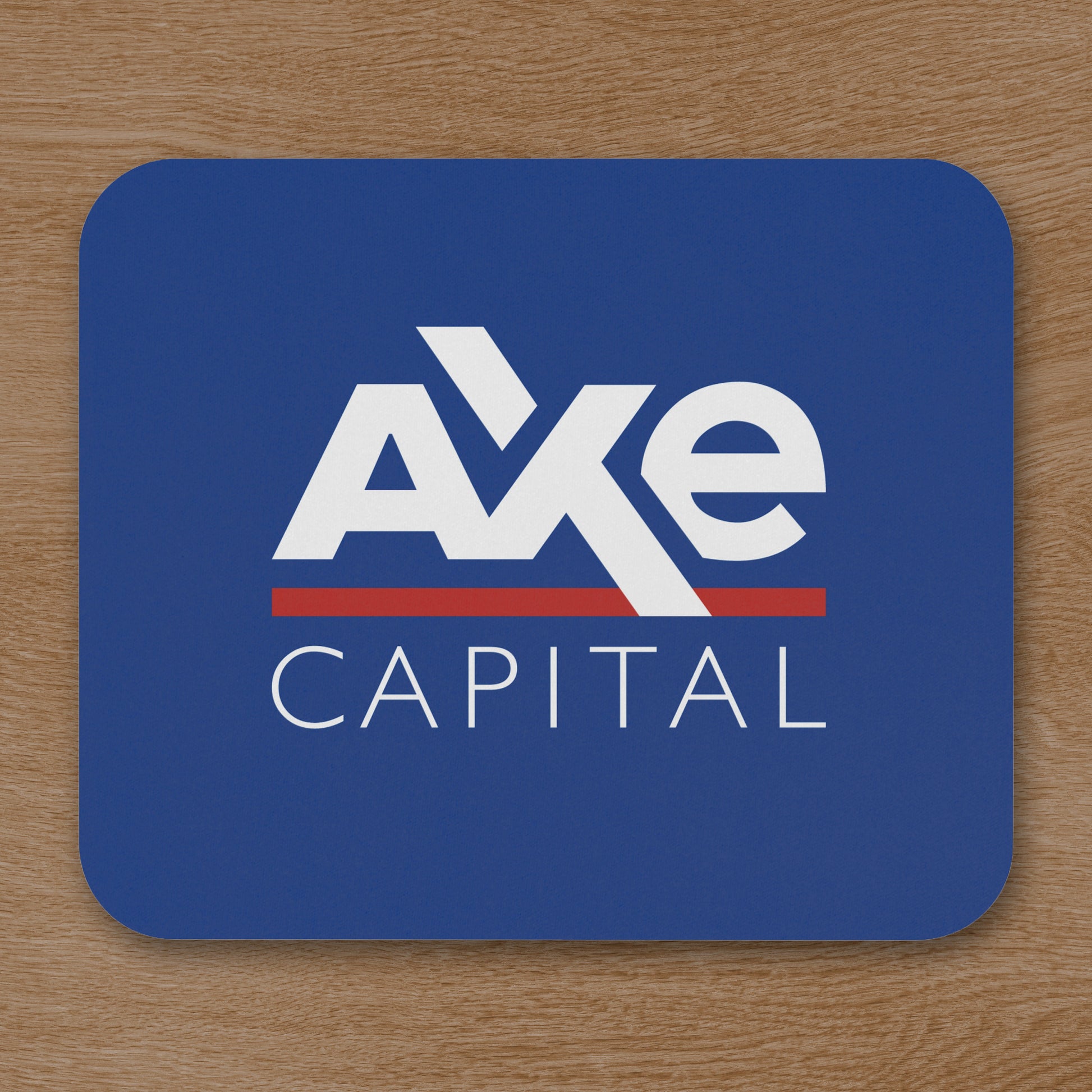 Topdown view of blue Axe Capital mouse pad inspired by the TV show Billions, shown on a wooden desk.