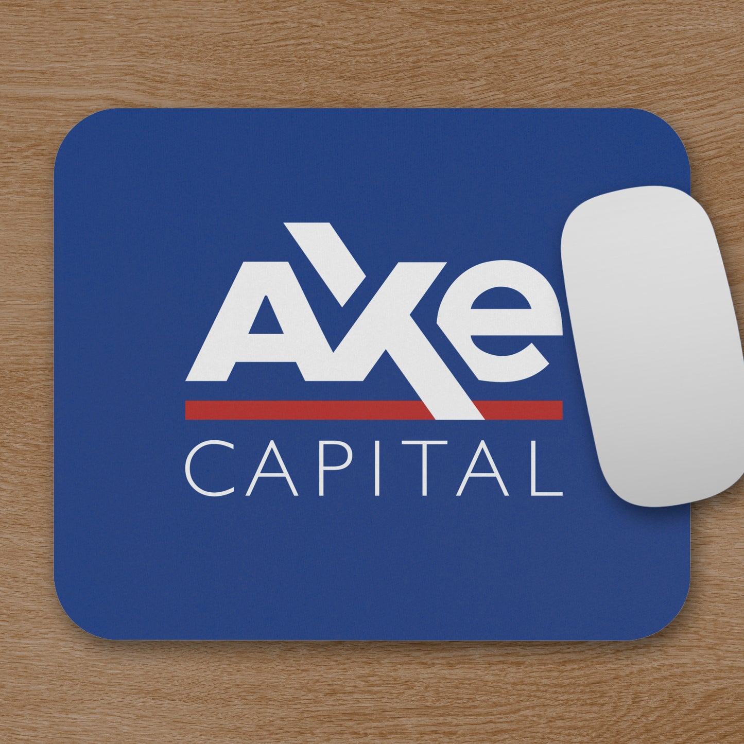 Topdown view of blue Axe Capital mouse pad inspired by the TV show Billions, shown with a mouse on a wooden desk.