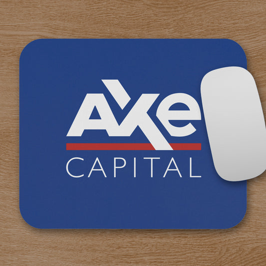 Topdown view of blue Axe Capital mouse pad inspired by the TV show Billions, shown with a mouse on a wooden desk.