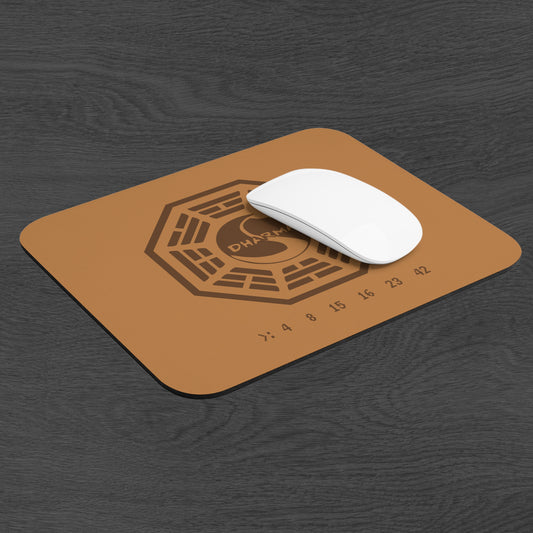 Angled view of tan 9x8 mouse pad with Dharma Initiative Swan Station logo and hatch numbers from TV show Lost, on a desk with a mouse