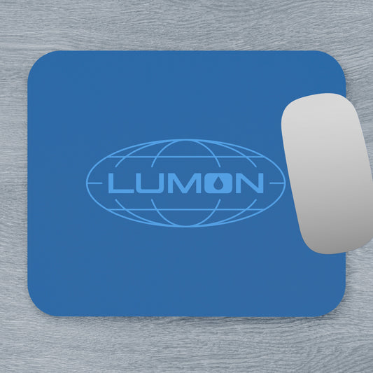 Top down view of a 9x8 modern blue Mouse pad with the Lumon Industries logo from the TV show Severance, next to a MacBook.