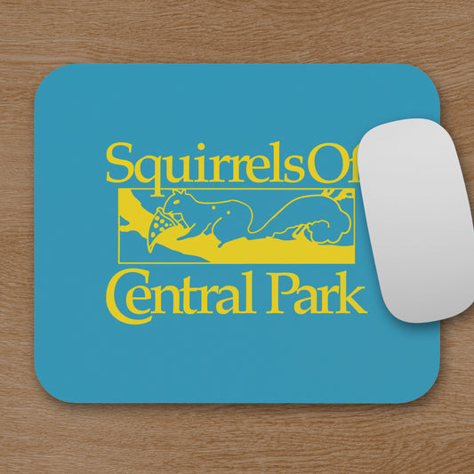Squirrels Of Central Park mouse pad in gold on blue inspired by Bad Sisters TV show, shown on a wooden desk with a mouse.