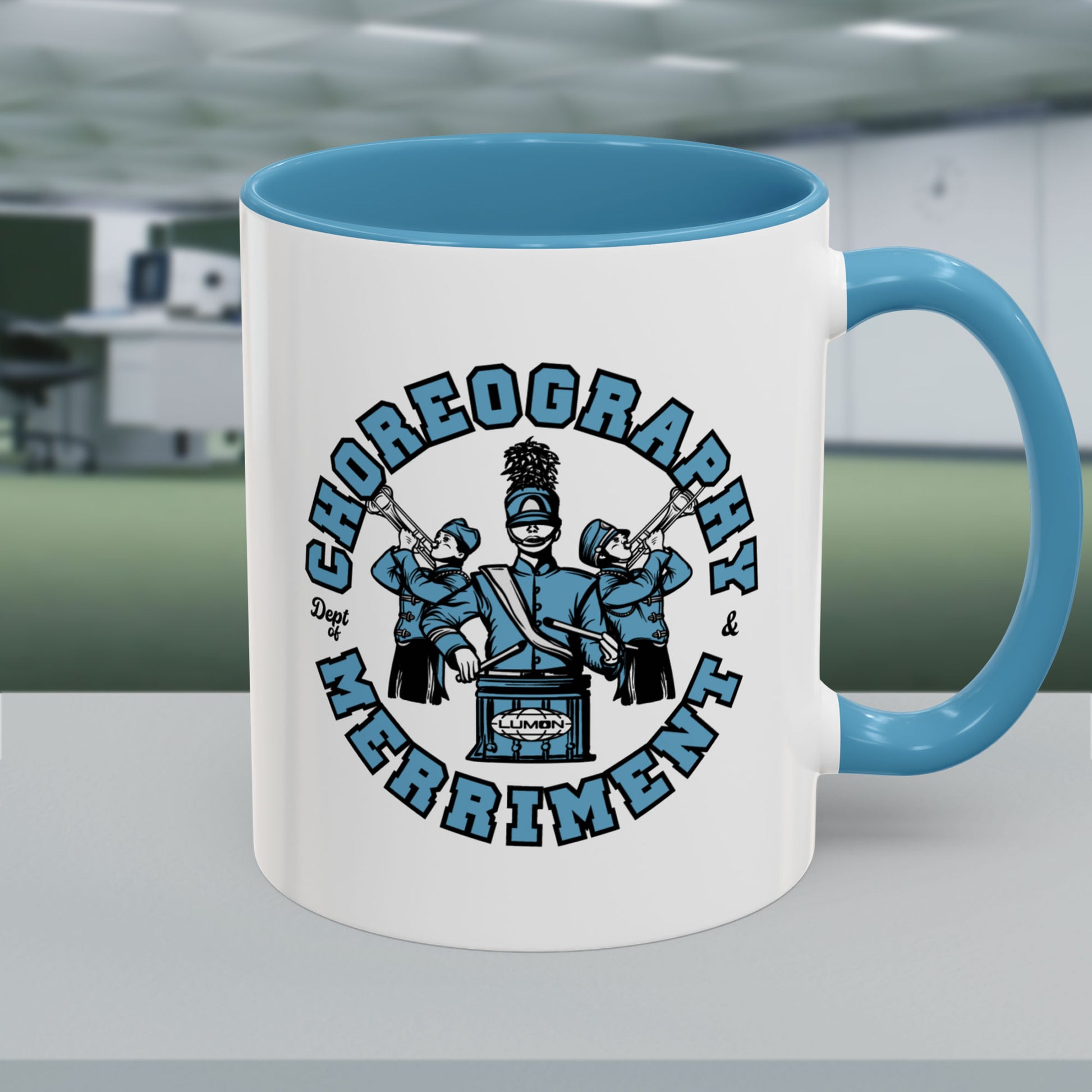 11 oz White ceramic accent mug with blue handle featuring Severance Dept. of Choreography & Merriment graphic.