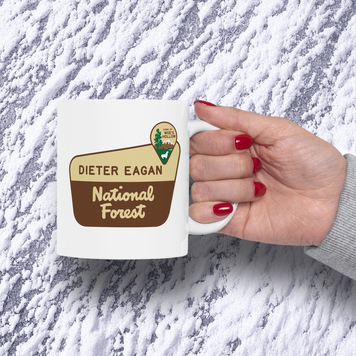 Hand holding 11 oz White ceramic mug with Dieter Eagan National Forest logo, inspired by Woe’s Hollow episode in Severance.