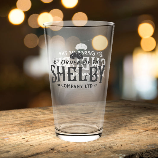 16 ounce Pint Glass with Shelby Company LTD logo from Peaky Blinders printed on both sides, shown in a bar.