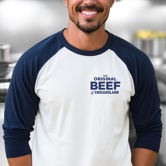 Man wearing The Bear Original Beef of Chicagoland raglan baseball t-shirt, white body with navy blue 3/4 sleeves and chest logo.