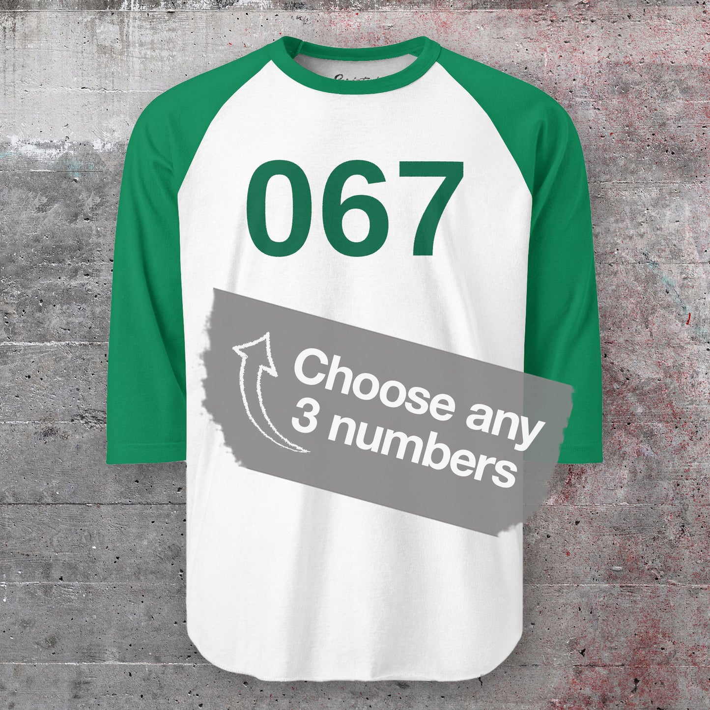 Green and White colored soft Tultex 245 Unisex Three-Quarter Sleeve Raglan Player T-Shirt featuring the numerals 067 from the popular TV series Squid Game. The shirt can be personalized by the customer to include any three digits.