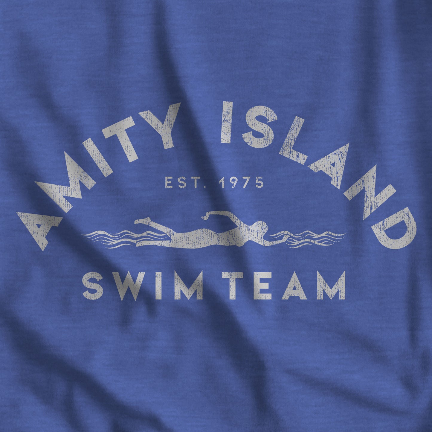 Closeup of Heather Royal Blue tee with vintage distressed Amity Island Swim Team Jaws-inspired swimmer logo