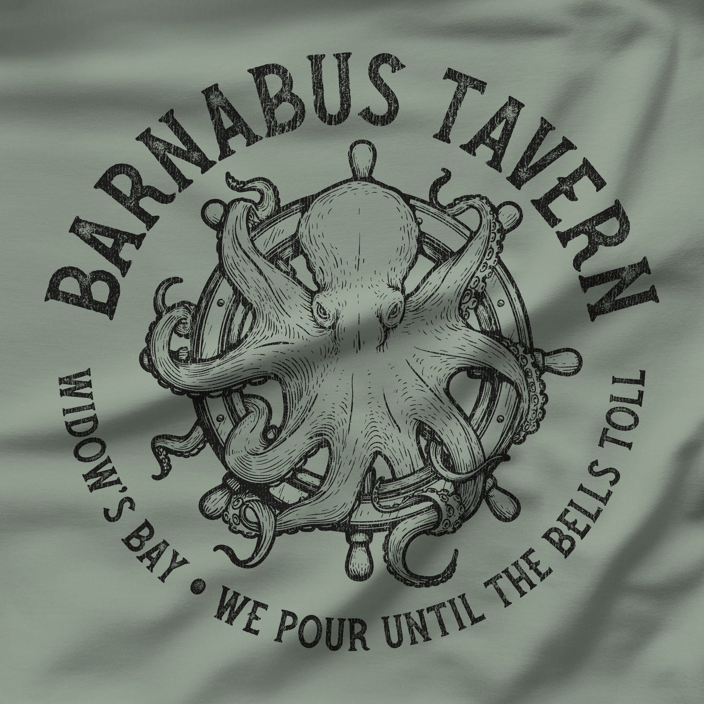 Closeup of Sage green tee with vintage engraved Barnabus Tavern octopus and ship's wheel Widow's Bay design
