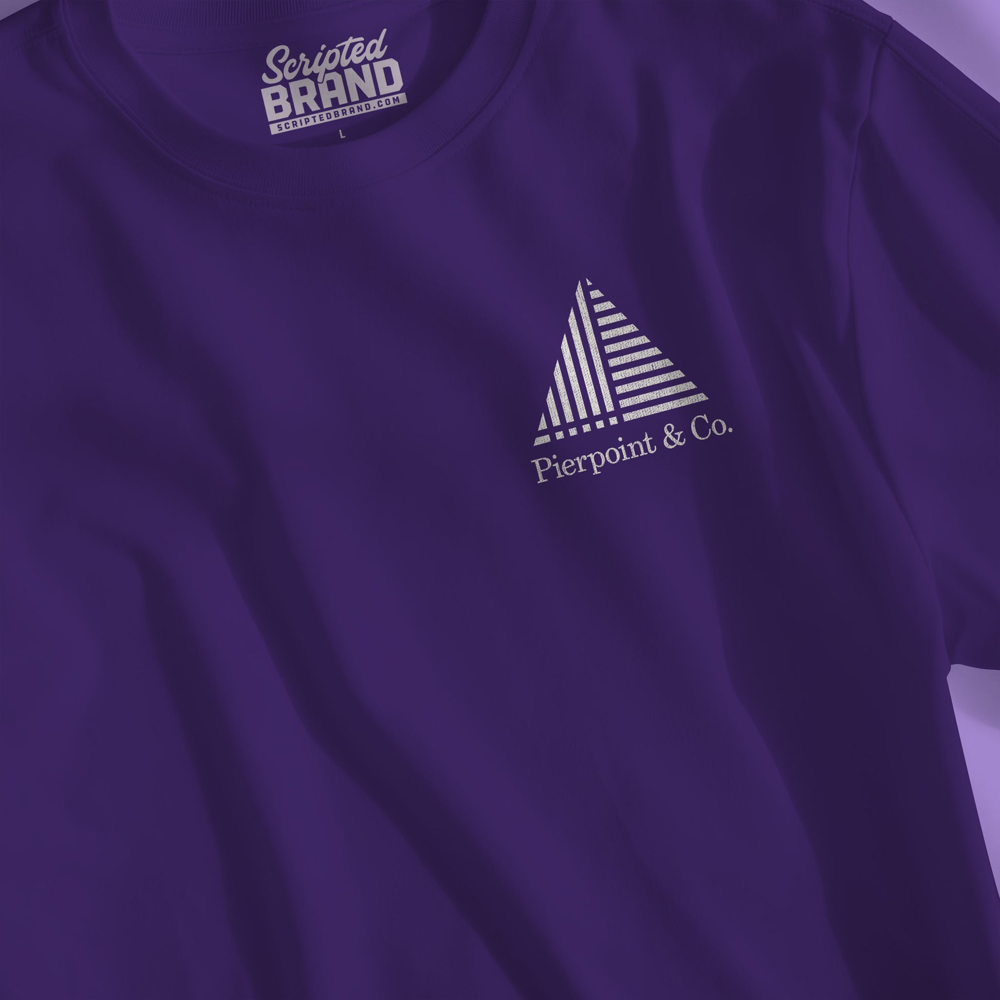 Closeup of purple Pierpoint & Co. corner logo t-shirt inspired by HBO Industry TV series, soft Bella+Canvas cotton investment bank fan tee
