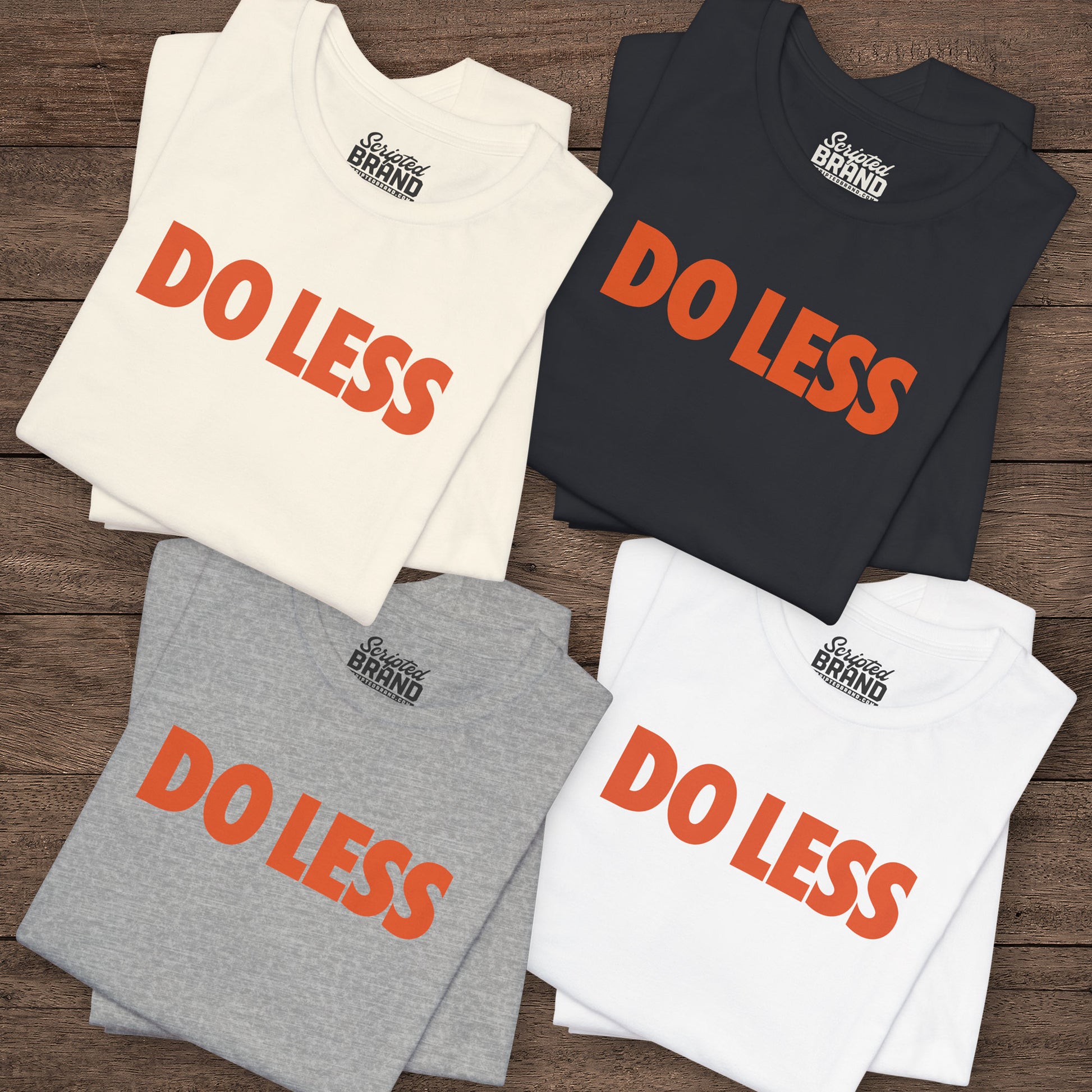 Four folded Do Less graphic t-shirts inspired by Shrinking TV show, Bella+Canvas cotton tees with orange type