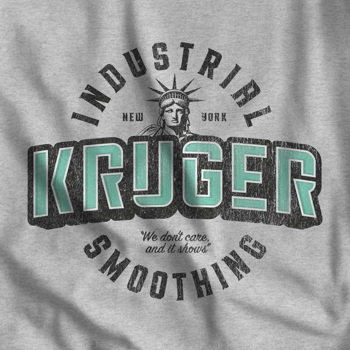 Closeup of heather gray Bella+Canvas t-shirt featuring a Kruger Industrial Smoothing logo graphic inspired by the TV show Seinfeld in a vintage distressed style.
