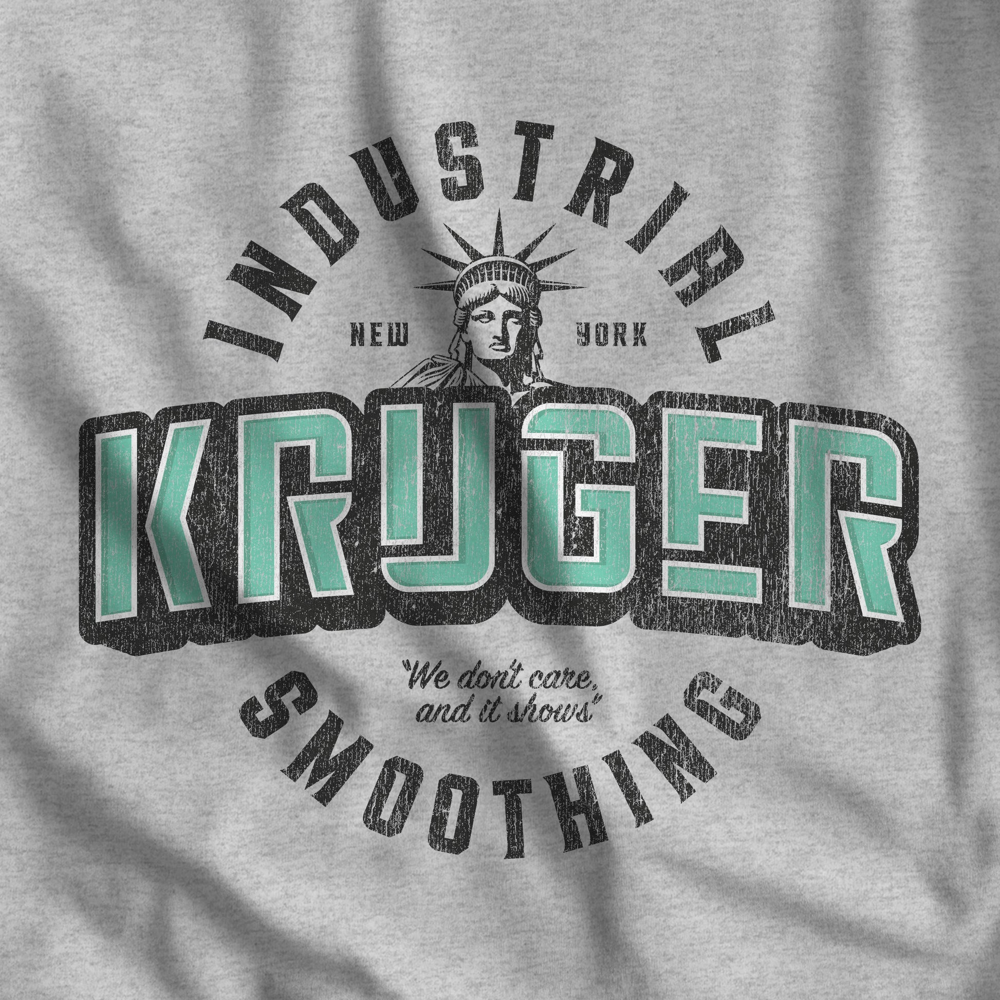 Closeup of heather gray Bella+Canvas t-shirt featuring a Kruger Industrial Smoothing logo graphic inspired by the TV show Seinfeld in a vintage distressed style.