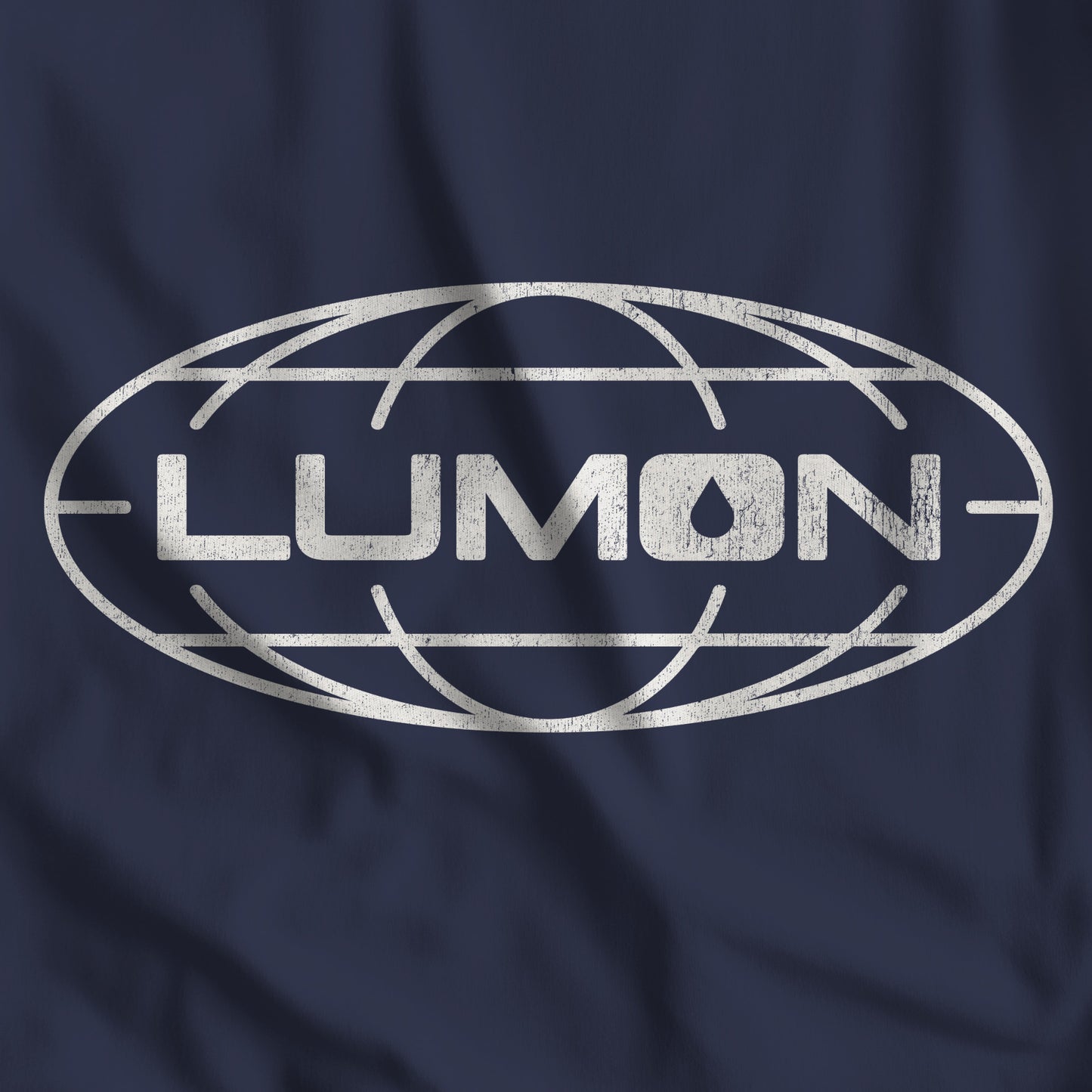 Closeup of Navy Bella+Canvas tee with a vintage distressed Lumon Industries globe logo from the Apple TV show Severance