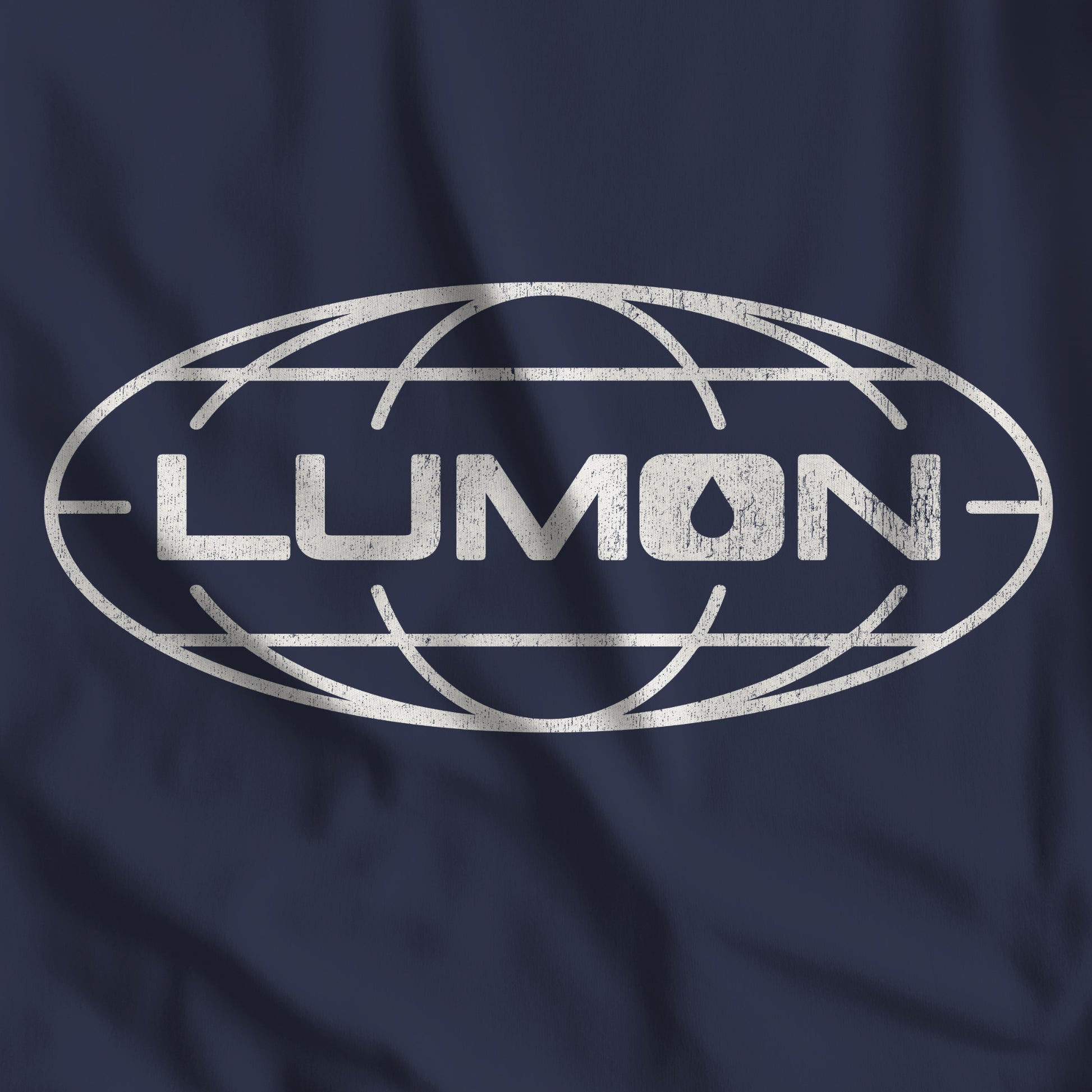 Closeup of Navy Bella+Canvas tee with a vintage distressed Lumon Industries globe logo from the Apple TV show Severance