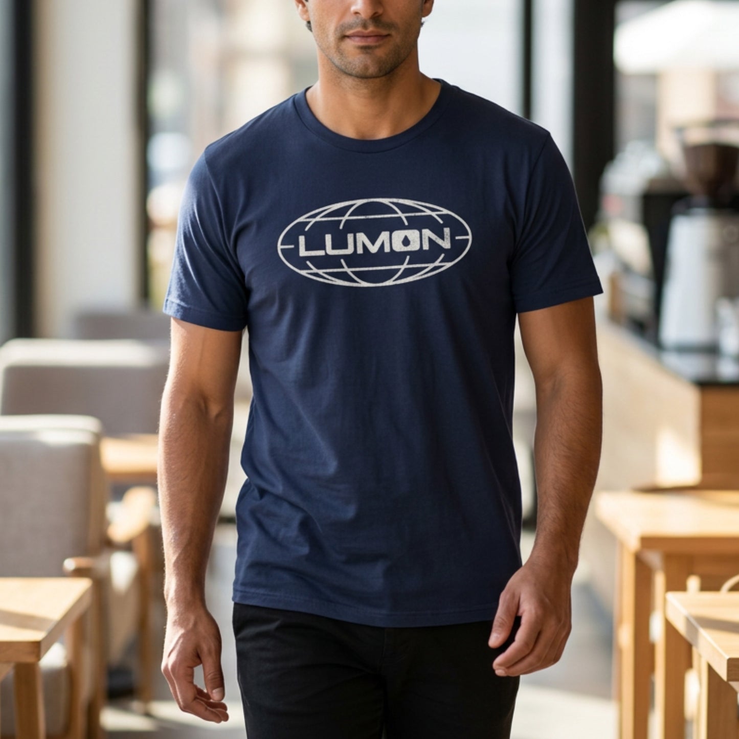 Man wearing Navy blue Bella+Canvas tee with a vintage distressed Lumon Industries globe logo from the Apple TV show Severance
