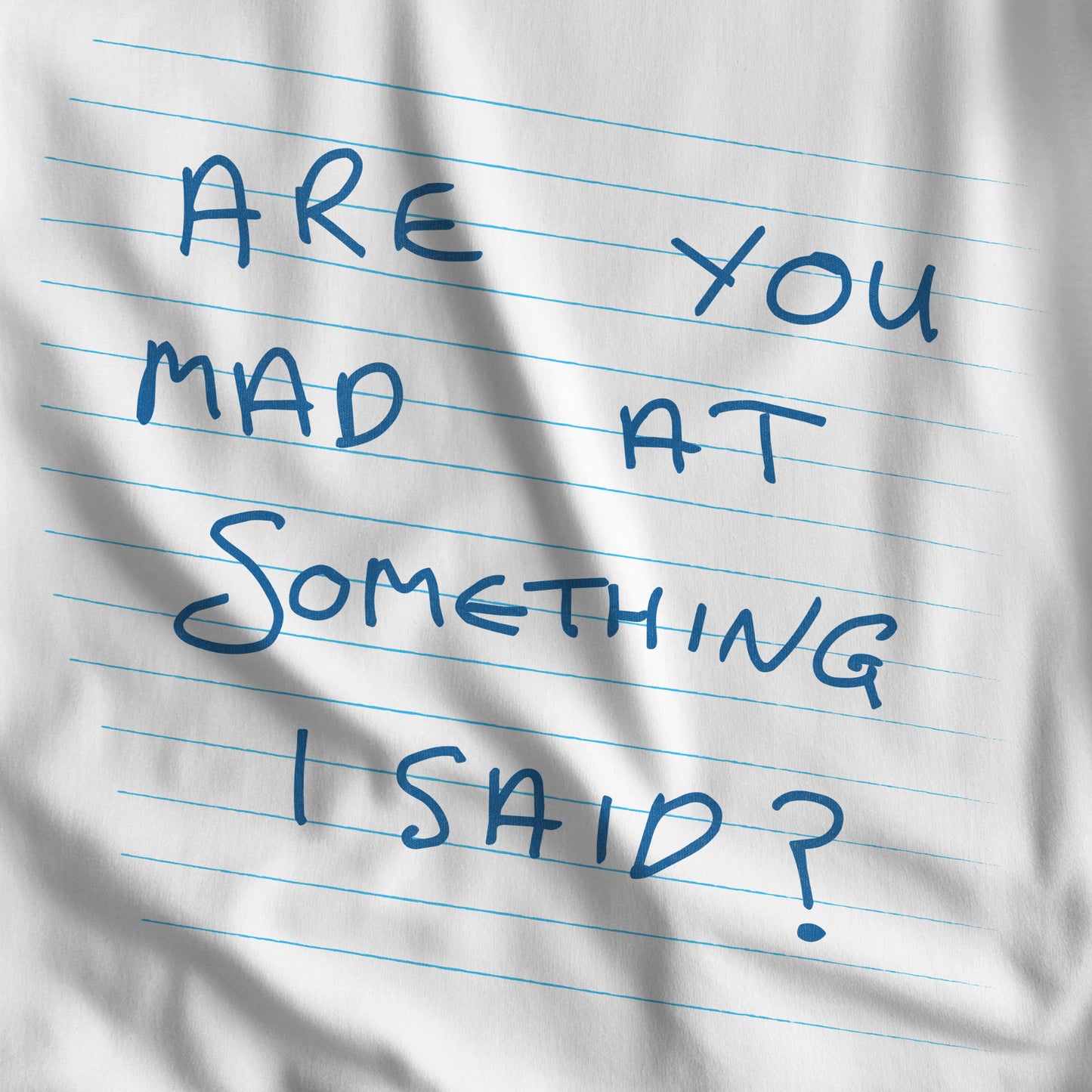 Closeup of White t-shirt with handwritten Patricia note from Widow's Bay reading "Are You Mad At Something I Said?"