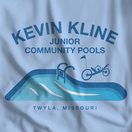 Closeup of DTF St. Louis Kevin Kline Junior Community Pools graphic tee with pool and recumbent trike, Bella+Canvas 3001 Light blue.