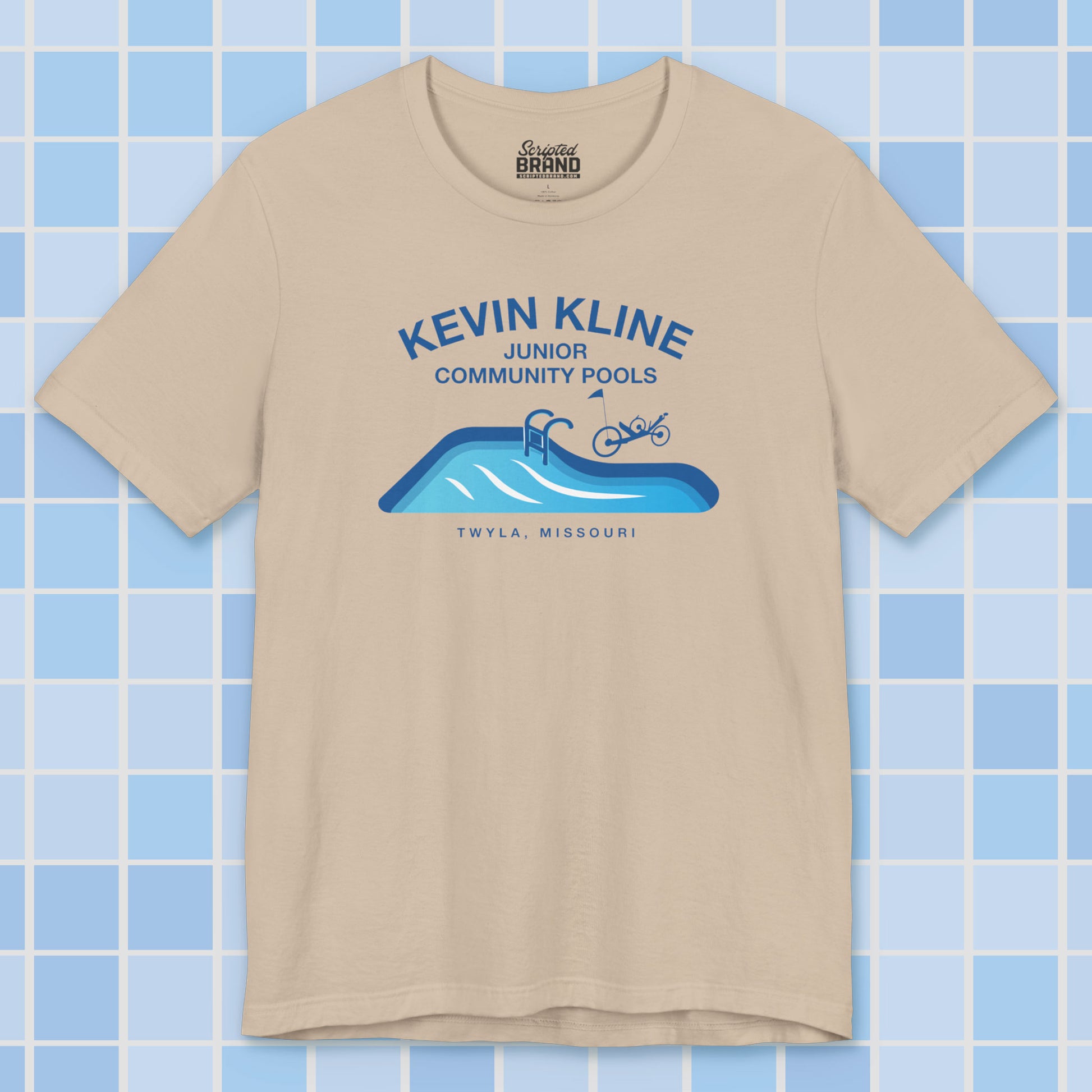 Tan DTF St. Louis Kevin Kline Junior Community Pools graphic tee with pool and recumbent trike, Bella+Canvas 3001.