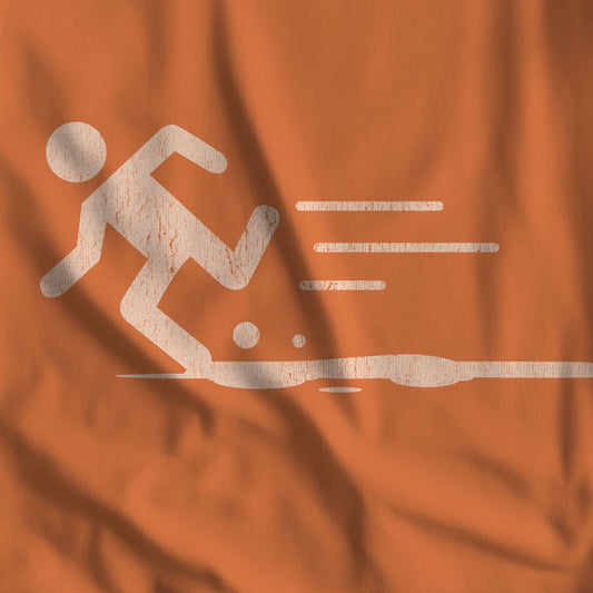 Closeup of Burnt orange tee with vintage distressed Portal 2 Propulsion Gel icon of a figure sprinting fast