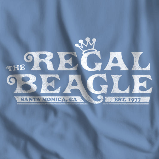 Closeup of Lavender Blue Bella+Canvas t-shirt with the Regal Beagle logo from the TV Show 'Threes Company' in a vintage distressed style.
