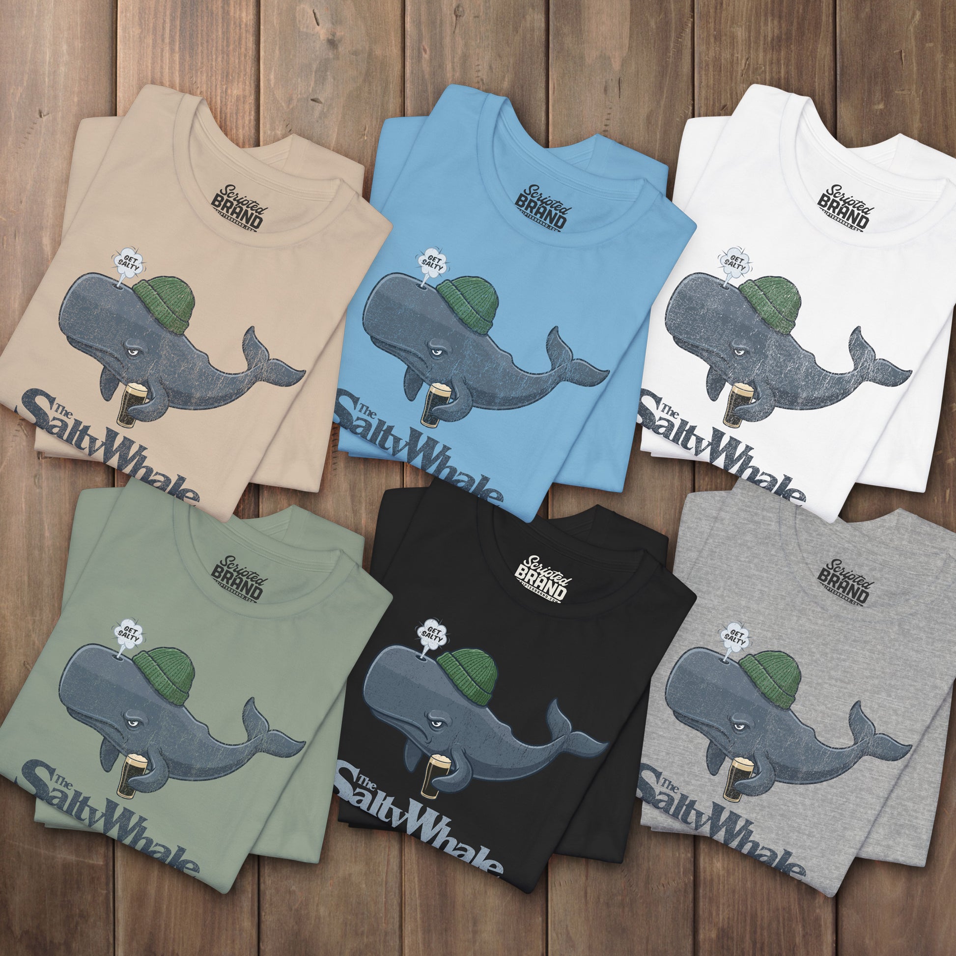 Six folded 'The Salty Whale' cartoon mascot t-shirts inspired by Widow's Bay Apple TV series, soft Bella+Canvas cotton pub fan tee