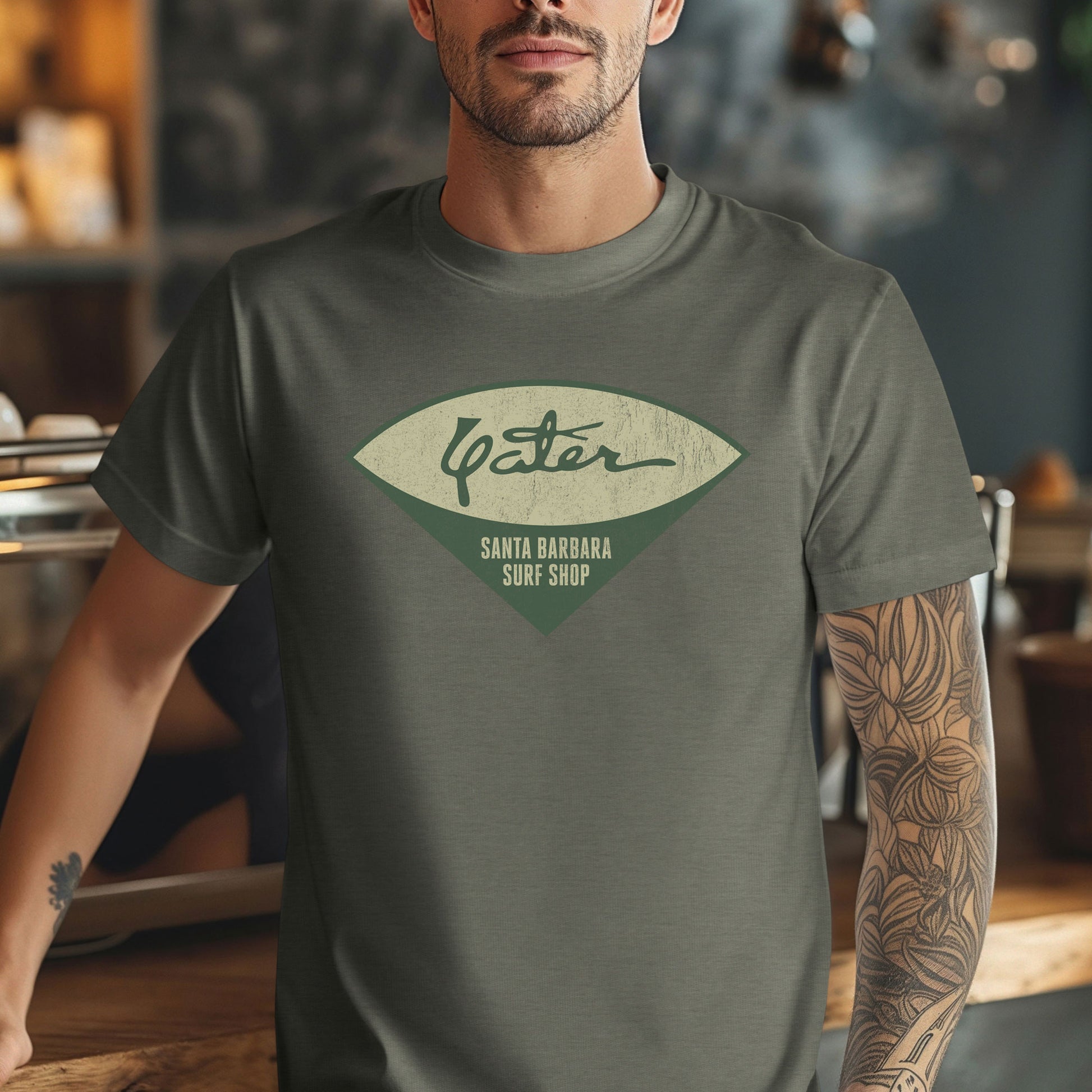 Man wearing Yater Surf Shop vintage distressed t-shirt in heather military green, Bella+Canvas 3001, worn by Robert Duvall in Apocalypse Now.