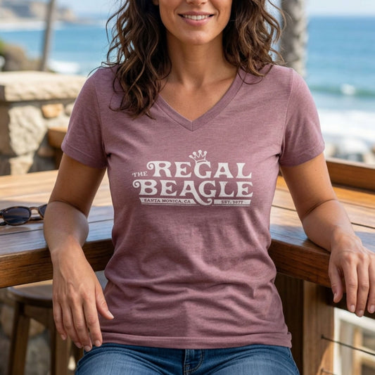 Person wearing Heather mauve womens v-neck tee with vintage distressed Regal Beagle Three's Company logo