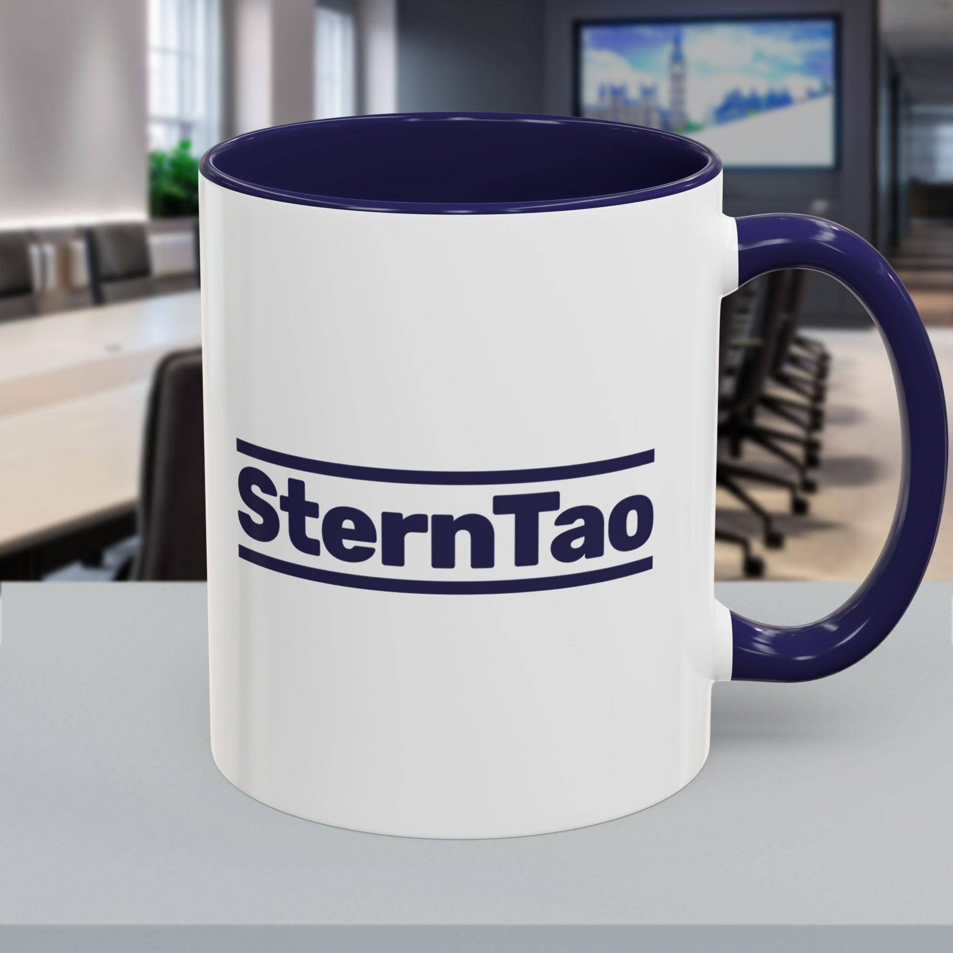 Front view of SternTao logo navy accent mug inspired by Industry, white ceramic coffee mug with navy handle, two sided print
