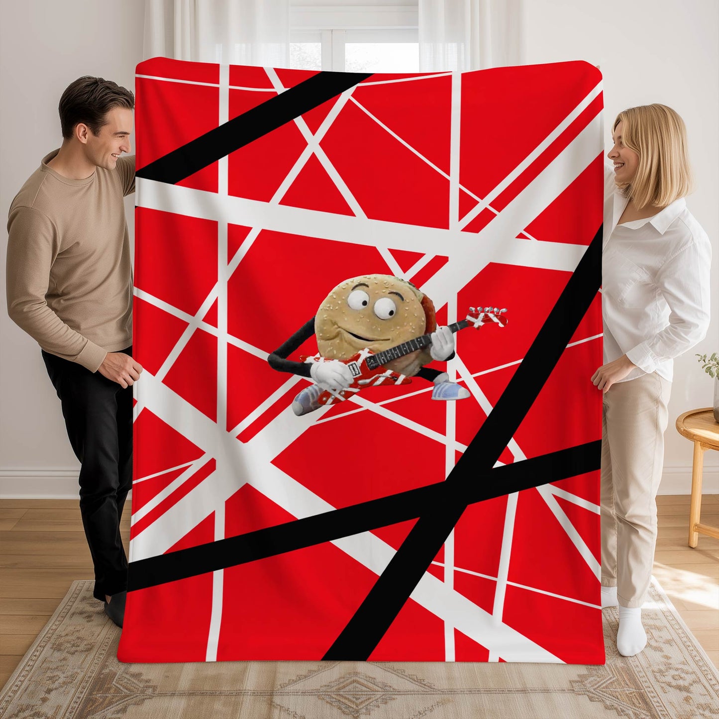 Two people holding 60x80 plush blanket with red, white, black Frankenstein stripes with singing hamburger guitar graphic, inspired by Better Off Dead and Van Halen.
