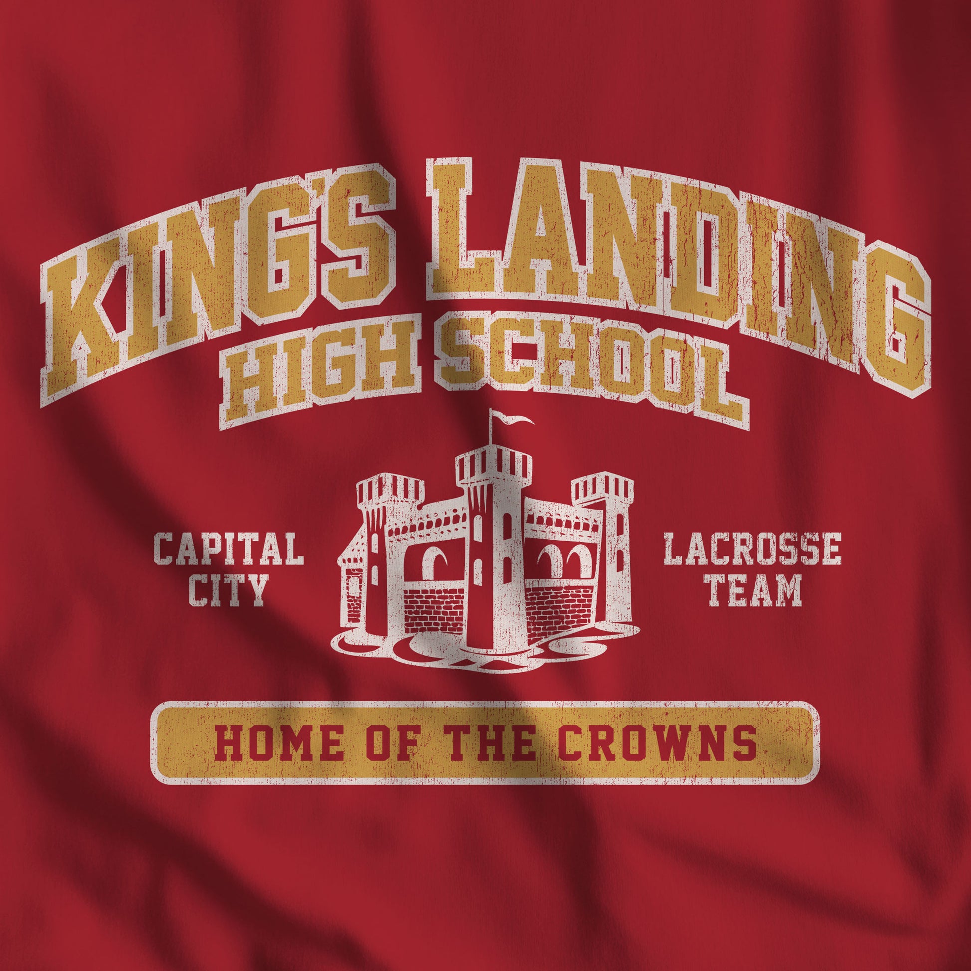 Closeup of Red and Gold 'King's Landing High School' t-shirt with vintage castle graphic inspired by Game of Thrones