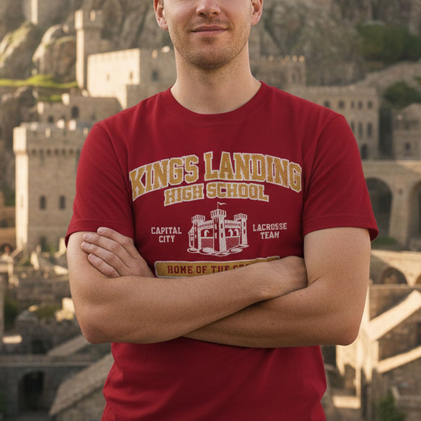 Person wearing Red and Gold King's Landing High School t-shirt with vintage castle graphic inspired by Game of Thrones.
