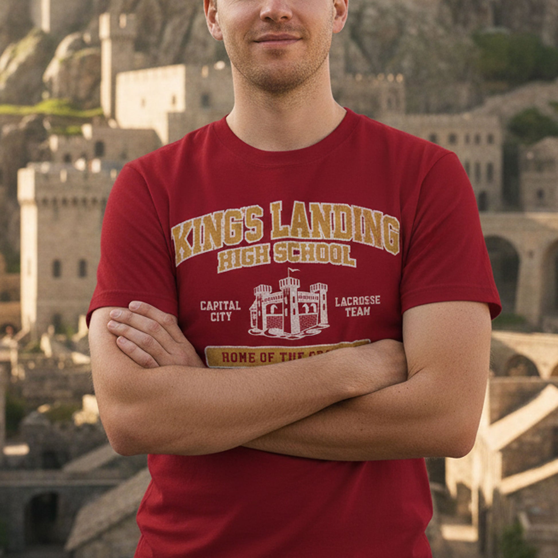 Person wearing Red and Gold King's Landing High School t-shirt with vintage castle graphic inspired by Game of Thrones.