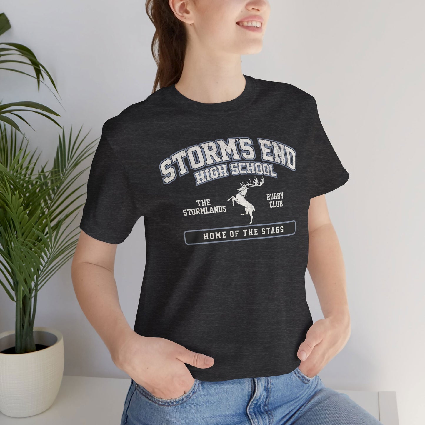 Woman wearing Dark grey heather Storm's End High School t-shirt with vintage deer graphic inspired by Game of Thrones and House Baratheon.