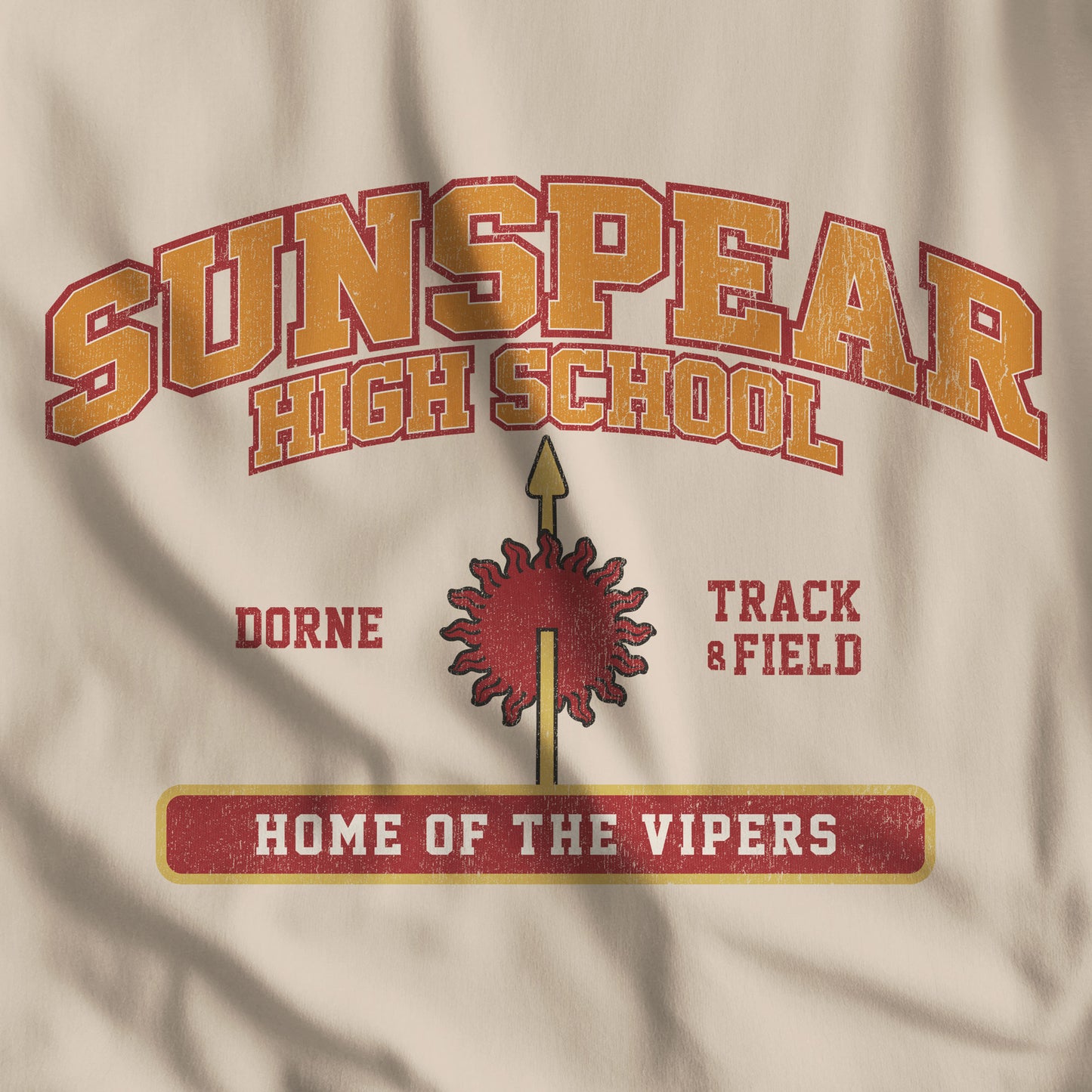 Closeup of tan beige Sunspear High School t-shirt with distressed dorne sun graphic inspired by Game of Thrones