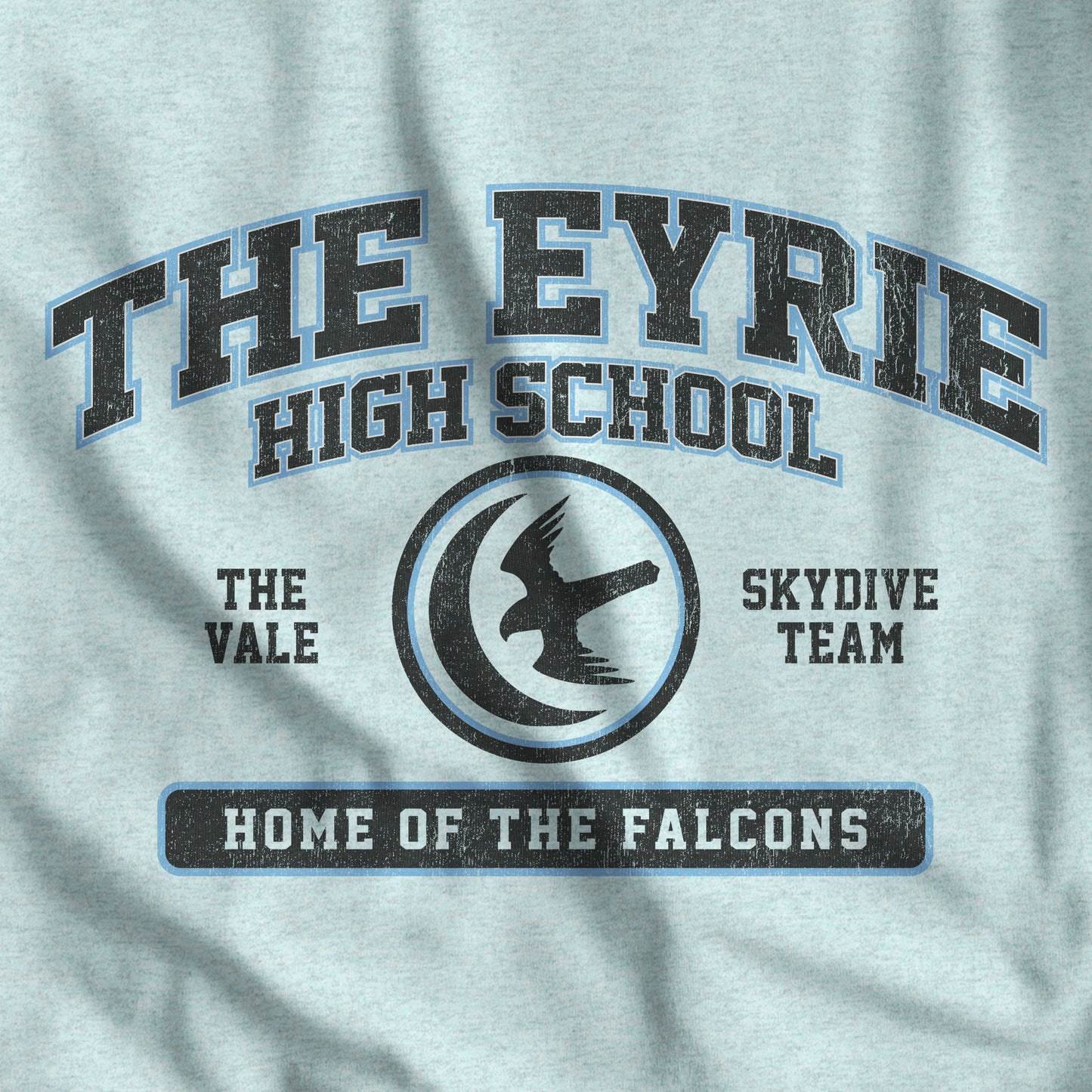 Closeup of heather prism ice blue 'The Eyrie High School' t-shirt with vintage falcon moon door graphic inspired by Game of Thrones and the Vale