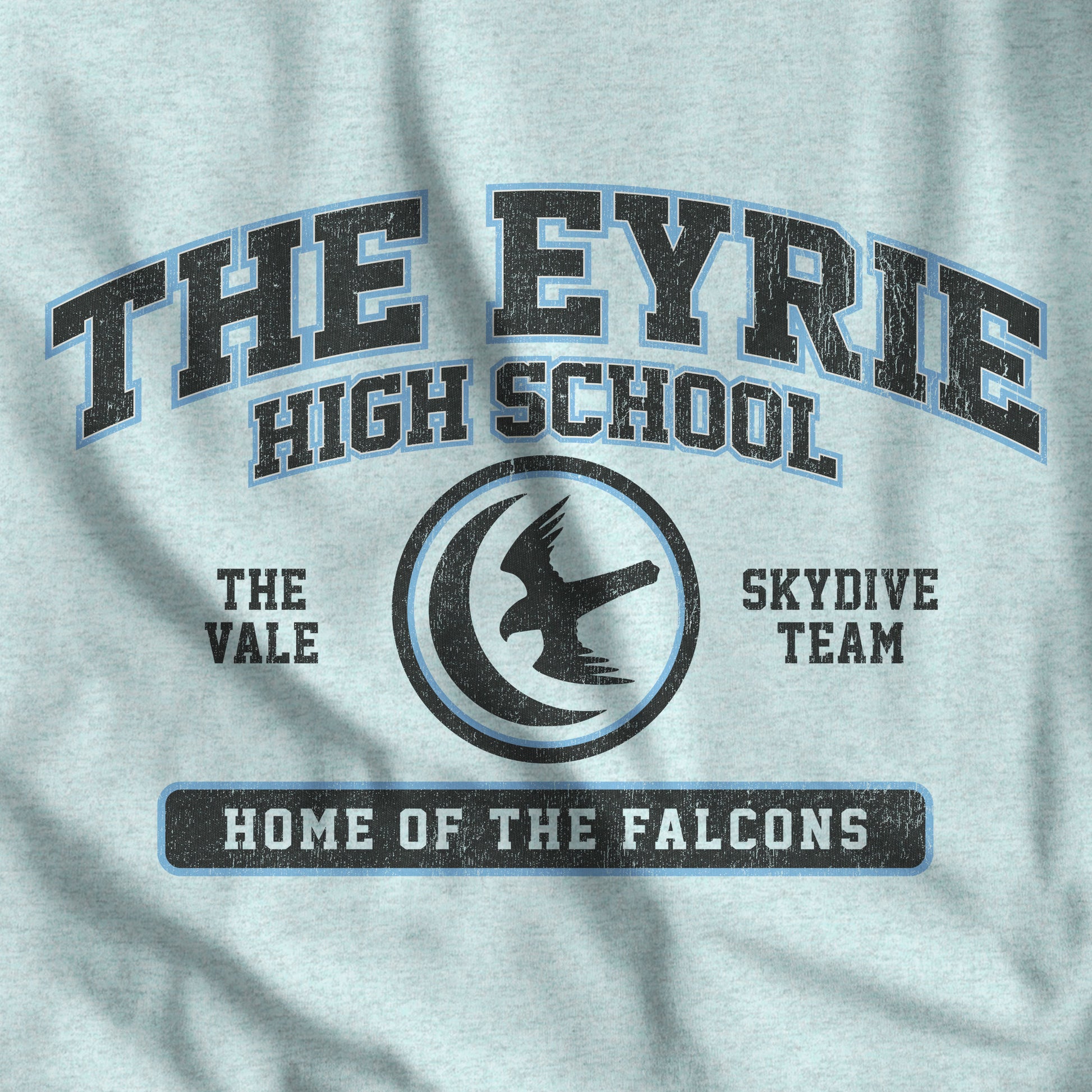 Closeup of heather prism ice blue 'The Eyrie High School' t-shirt with vintage falcon moon door graphic inspired by Game of Thrones and the Vale