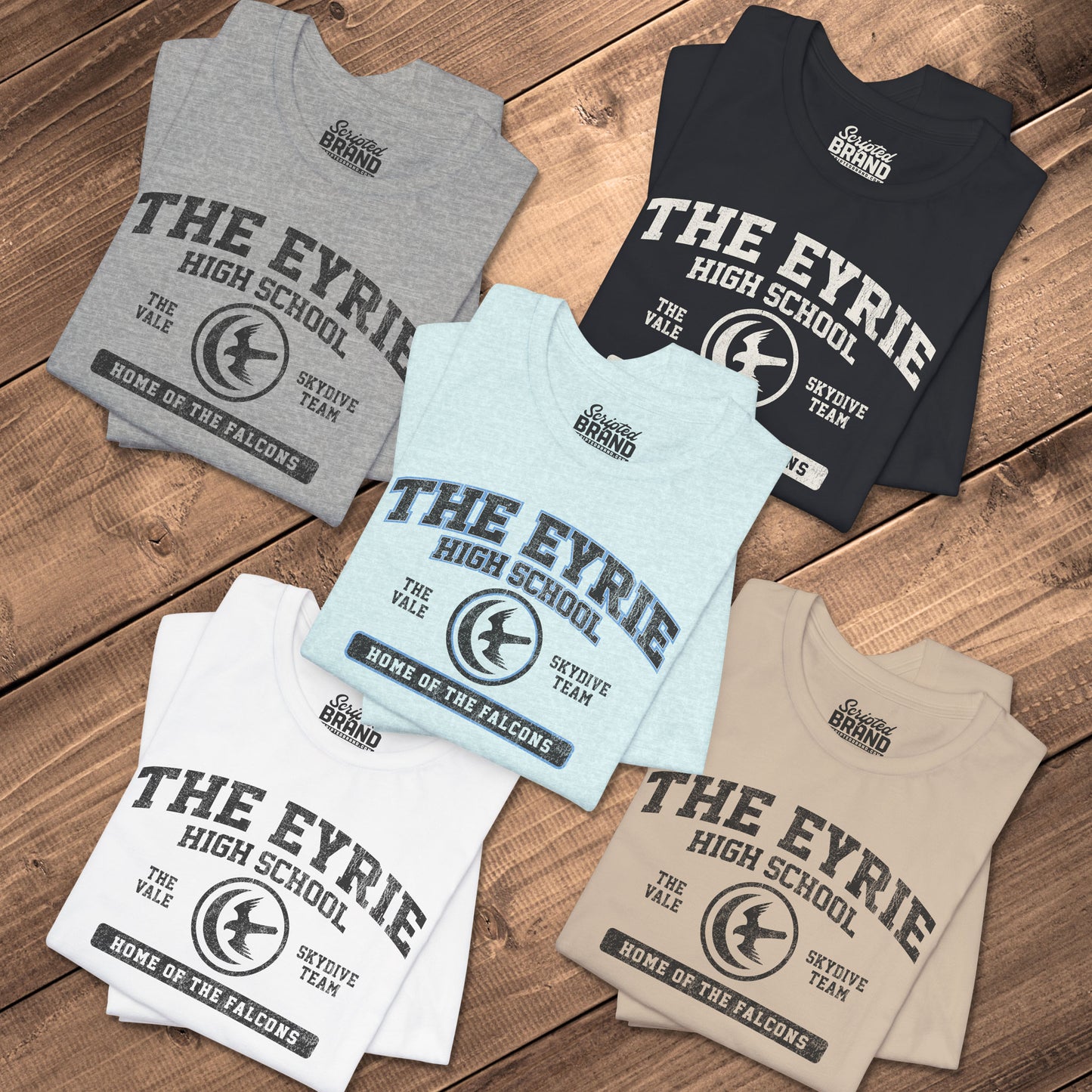 Five folded The Eyrie High School t-shirts with vintage falcon moon door graphic inspired by Game of Thrones and the Vale.