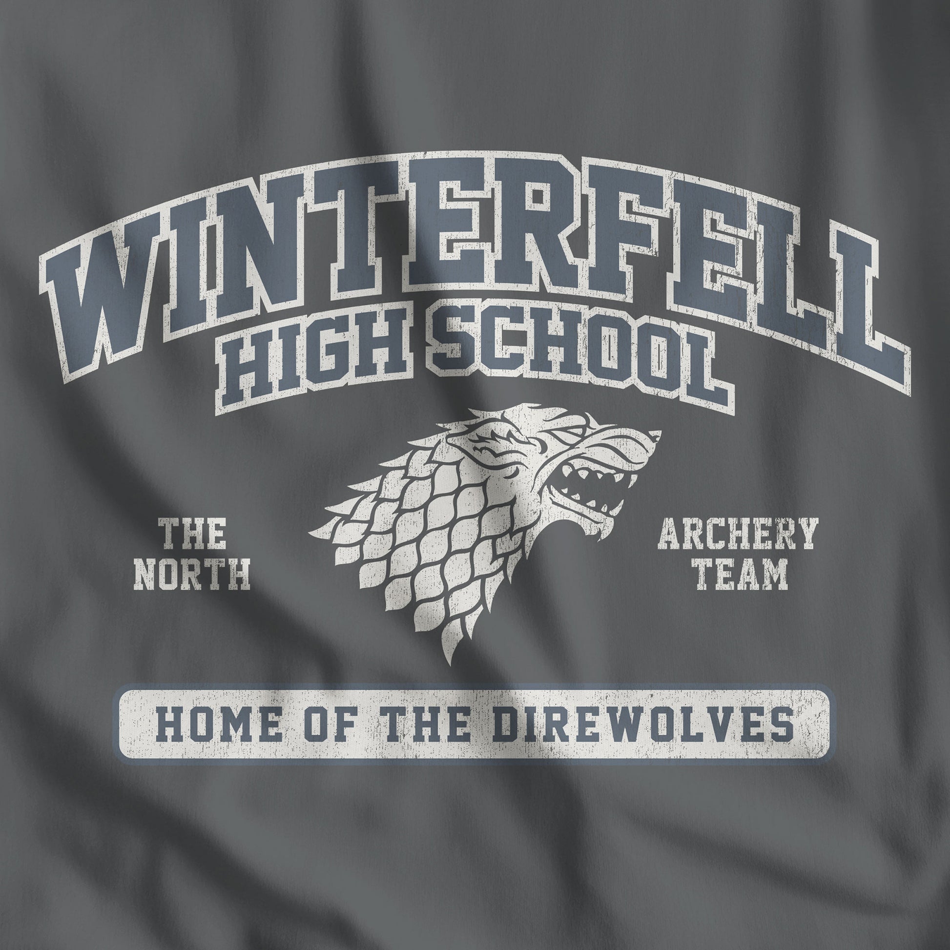 Closeup of Asphalt Dark Gray Winterfell High School t-shirt with vintage direwolf graphic inspired by Game of Thrones