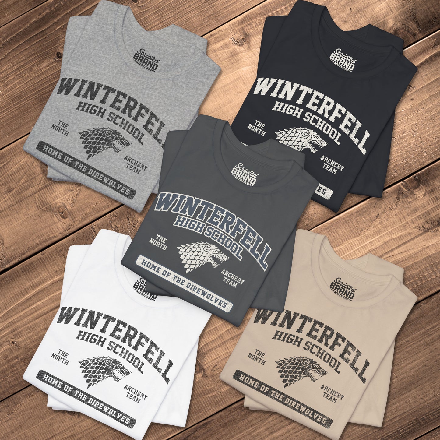 Five folded Winterfell High School t-shirts with vintage direwolf graphic inspired by Game of Thrones.
