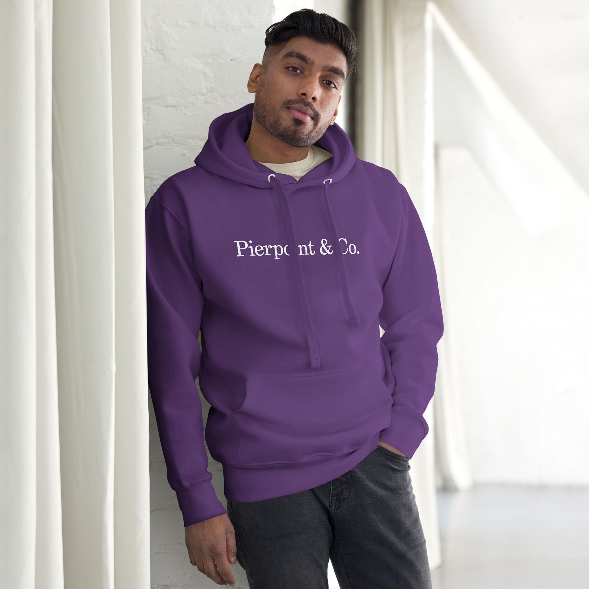 Man wearing a Purple Pierpoint & Co. logo premium pullover hoodie inspired by HBO Industry TV series, unisex cotton blend sweatshirt
