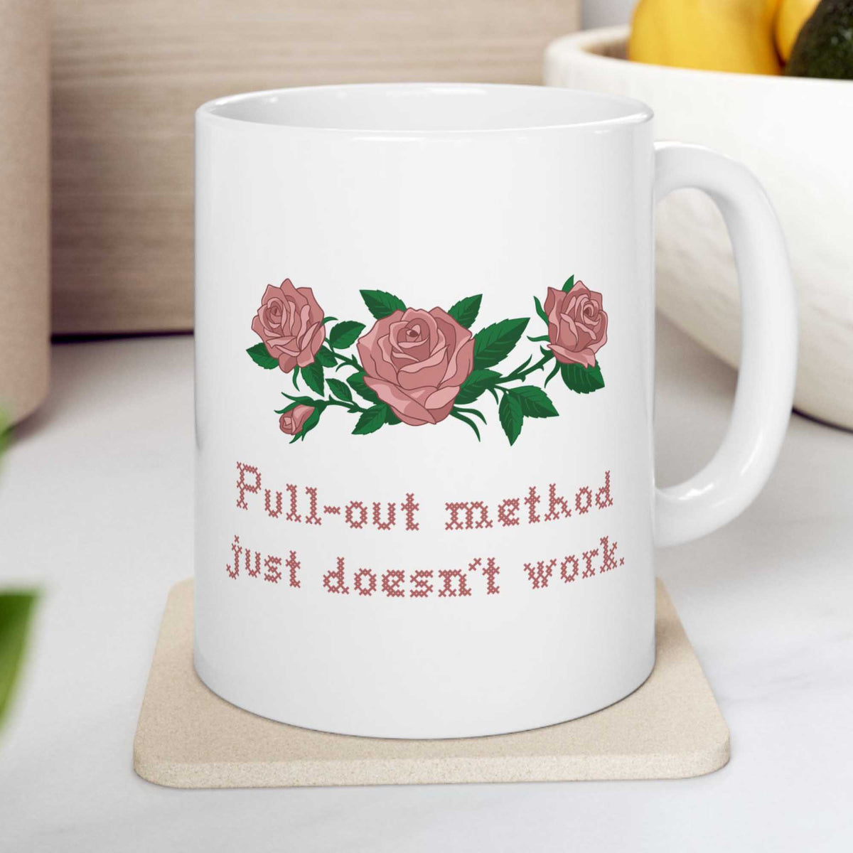 White mug on a coaster with pink roses and Pull-out method just doesn't work in cross stitch, inspired by Ruth in Widow's Bay
