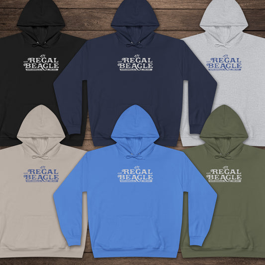 Six Hanes EcoSmart pullover hoodies with vintage distressed Regal Beagle logo from Three’s Company on chest, shown on wood floor.