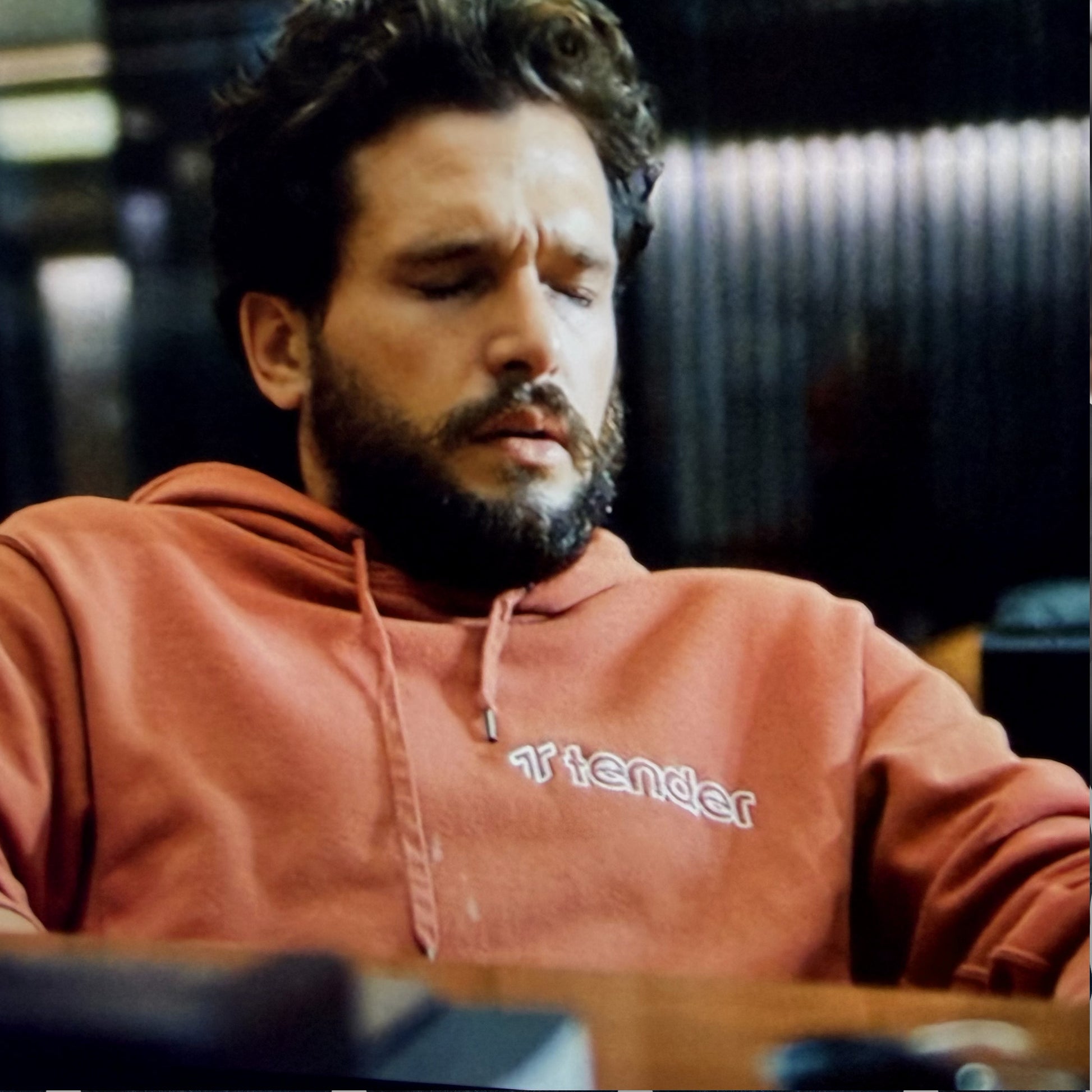 Kit Harington wearing a Texas Orange Tender logo hoodie sweatshirt in HBO show Industry.