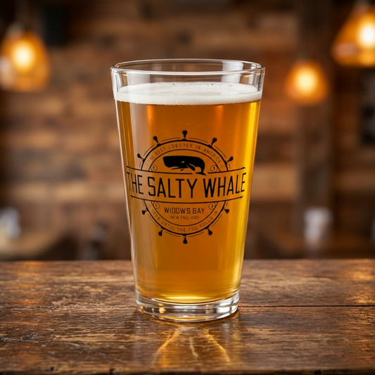 Clear 16 oz pint glass with the vintage black Salty Whale maritime crest logo from Widow's Bay, New England